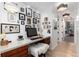 This home office has pictures and a computer on a white desk at 3925 S Cherry St, Englewood, CO 80113