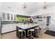 Bright kitchen with an island, modern appliances, white cabinetry, and plenty of natural light at 3925 S Cherry St, Englewood, CO 80113