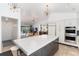 Open concept living area with kitchen, bar, stainless appliances and ample lighting at 3925 S Cherry St, Englewood, CO 80113
