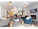 Bright, open-concept living room with comfortable seating, a fireplace, and seamless access to dining at 3925 S Cherry St, Englewood, CO 80113