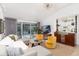 Cozy living area with stylish furniture, a built-in bar, and a sliding glass door to the patio at 3925 S Cherry St, Englewood, CO 80113