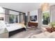The main bedroom showcases a bed, drapes, seating and television at 3925 S Cherry St, Englewood, CO 80113