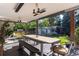 Outdoor patio with a dining table, grill, and lush landscaping at 3925 S Cherry St, Englewood, CO 80113