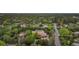 Picturesque aerial view of a residence surrounded by mature trees in a lush, green setting at 6616 E Prentice Ave, Greenwood Village, CO 80111