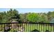 Scenic backyard view from balcony showcasing mature trees and landscaped grounds at 6616 E Prentice Ave, Greenwood Village, CO 80111