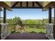 Outdoor balcony with stone columns overlooking a lush, green, landscaped backyard at 6616 E Prentice Ave, Greenwood Village, CO 80111