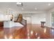 Finished basement with hardwood floors, bar, and staircase leading to an upper floor of the home at 6616 E Prentice Ave, Greenwood Village, CO 80111