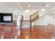 Finished basement with hardwood floors, a wet bar, and a staircase leading to the upper level at 6616 E Prentice Ave, Greenwood Village, CO 80111