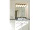 Bright bathroom features custom cabinets, granite counters, and a large illuminated mirror at 6616 E Prentice Ave, Greenwood Village, CO 80111