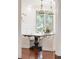 Elegant dining room with hardwood floors, sophisticated chandeliers, and a bay window providing natural light at 6616 E Prentice Ave, Greenwood Village, CO 80111