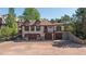 Tudor-style home featuring a private garage, stone accents, and mature landscaping at 6616 E Prentice Ave, Greenwood Village, CO 80111