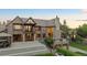 Beautiful brick home with stone accents, a stone chimney, and a well-manicured lawn at 6616 E Prentice Ave, Greenwood Village, CO 80111