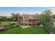 Expansive home features a lush lawn, stone accents, and a charming gazebo at 6616 E Prentice Ave, Greenwood Village, CO 80111