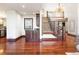Grand foyer featuring a staircase with wrought iron railings and elegant lighting fixtures at 6616 E Prentice Ave, Greenwood Village, CO 80111