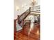 Impressive foyer with a grand staircase, hardwood floors, and elegant lighting, creating a welcoming entrance at 6616 E Prentice Ave, Greenwood Village, CO 80111