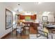 Well-lit kitchen has sleek countertops, wooden cabinetry, and an adjacent dining area at 6616 E Prentice Ave, Greenwood Village, CO 80111
