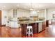 Expansive kitchen featuring custom cabinetry, stainless steel appliances, and a large island with bar seating at 6616 E Prentice Ave, Greenwood Village, CO 80111