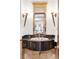 Chic powder room with a decorative sink, ornate mirror, and designer lighting fixtures at 6616 E Prentice Ave, Greenwood Village, CO 80111