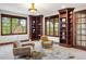 Inviting study with custom shelving, plush seating, and ample natural light at 6616 E Prentice Ave, Greenwood Village, CO 80111