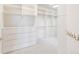 Spacious walk-in closet with custom shelving, drawers, and ample storage space at 6616 E Prentice Ave, Greenwood Village, CO 80111