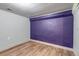 Finished basement featuring blue accent wall and wood flooring at 3151 N Elizabeth St, Denver, CO 80205