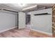 Finished basement with open door revealing an unfinished portion at 3151 N Elizabeth St, Denver, CO 80205