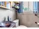 Rustic bathroom featuring a vessel sink, industrial shelving, and natural light at 3151 N Elizabeth St, Denver, CO 80205