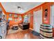 Cozy living room with hardwood floors, orange walls, and a barrel-themed side table at 3151 N Elizabeth St, Denver, CO 80205