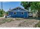 Rear view of the blue brick home showing the roof, and windows on a sunny day at 3151 N Elizabeth St, Denver, CO 80205