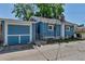 Back of the blue brick home showing the garage, yard, and alley access at 3151 N Elizabeth St, Denver, CO 80205