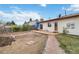 Spacious backyard with a patio, garden beds, and mature trees for outdoor enjoyment at 9698 Pecos St, Thornton, CO 80260