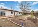 Spacious backyard with a patio, garden beds, and mature trees for outdoor enjoyment at 9698 Pecos St, Thornton, CO 80260
