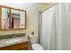 Bathroom featuring a shower with a curtain, granite countertop, and a wooden cabinet at 9698 Pecos St, Thornton, CO 80260