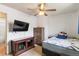 Bedroom with a wall-mounted TV, dresser, and comfortable bed with blue accents at 9698 Pecos St, Thornton, CO 80260