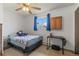 Bright bedroom with a twin bed, a ceiling fan, and a window with blue curtains at 9698 Pecos St, Thornton, CO 80260