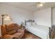 Bedroom showcasing a wrought iron bed frame, a leather armchair, and wood-look flooring at 9698 Pecos St, Thornton, CO 80260