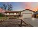 Charming ranch-style home featuring a brick facade, well-kept lawn, and inviting curb appeal enhanced by a beautiful sunset backdrop at 9698 Pecos St, Thornton, CO 80260