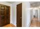 A bright hallway featuring wood floors and doors at 9698 Pecos St, Thornton, CO 80260