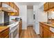 Functional kitchen with white appliances, wooden cabinets, and laminate countertops at 9698 Pecos St, Thornton, CO 80260