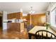 Inviting eat-in kitchen featuring wood cabinets, laminate countertops, and a dining table at 9698 Pecos St, Thornton, CO 80260