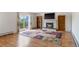 Living room features a fireplace, wood floors, and a sliding glass door at 9698 Pecos St, Thornton, CO 80260