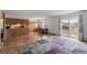 Open-concept living area with dining space featuring wood floors and a sliding glass door at 9698 Pecos St, Thornton, CO 80260