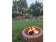 A backyard featuring lush greenery and a cozy stone fire pit, perfect for outdoor entertaining and relaxation at 1300 Kennedy Dr, Northglenn, CO 80234
