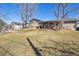 The backyard includes a brick fire pit, deck, and a large yard space at 1300 Kennedy Dr, Northglenn, CO 80234