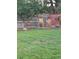 A large green yard with wood fencing, landscaping, and a bird bath at 1300 Kennedy Dr, Northglenn, CO 80234