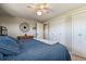 Comfortable bedroom featuring a ceiling fan, closet, and a soft blue comforter on the bed at 1300 Kennedy Dr, Northglenn, CO 80234