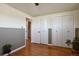 Bedroom featuring a ceiling fan, wall art, hardwood flooring, and closet doors at 1300 Kennedy Dr, Northglenn, CO 80234
