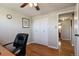 Bedroom featuring a ceiling fan, wall art, hardwood flooring, and white closet doors at 1300 Kennedy Dr, Northglenn, CO 80234