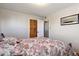 Bedroom featuring a wood bed frame, wood closet, and an open doorway at 1300 Kennedy Dr, Northglenn, CO 80234
