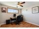 Bedroom with hardwood flooring, a ceiling fan, a desk and chair near a natural light window at 1300 Kennedy Dr, Northglenn, CO 80234